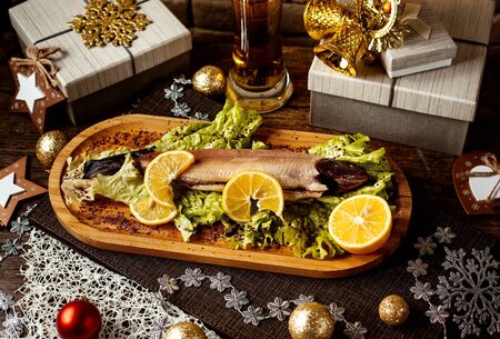 smoked fish with herbs and sliced lemonsの写真素材