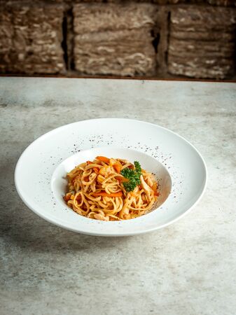 spaghetti with sliced vegetables and herbsの写真素材