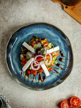 vegetable salad with slices of white cheeseの写真素材