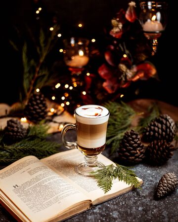 a cup of coffee on the bookの写真素材