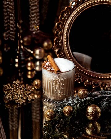 a coffee with whipped cream and cinnamonの写真素材