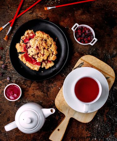 a cup of black tea and berry pieの写真素材