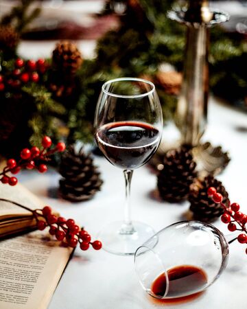 a glass of red wine and booksの写真素材