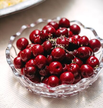 a glass plate with cherriesの写真素材