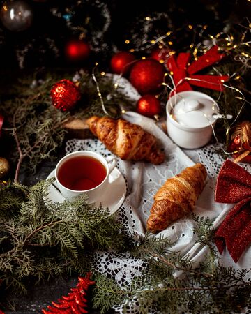 a pair of croissaints and cup of teaの写真素材