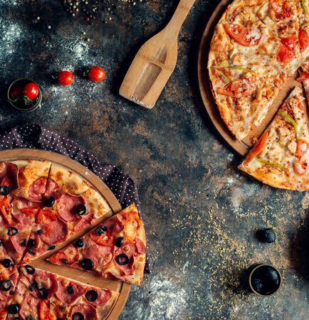 a pair of mixed piiza on the tableの写真素材