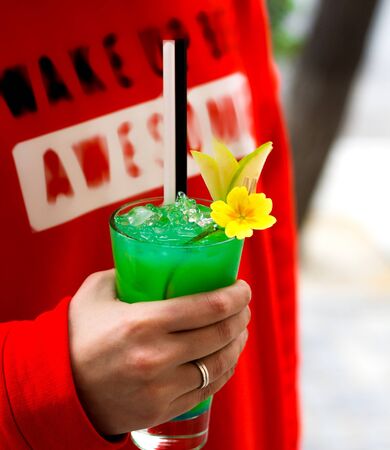 a person holding green ice teaの写真素材