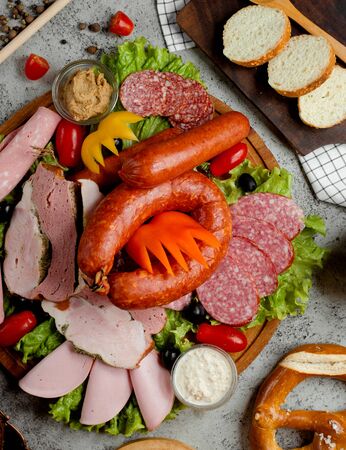 a plate with sausages and hamの写真素材