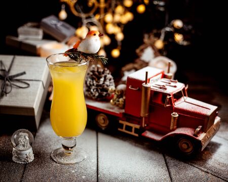 glass of orange juice with toy truckの写真素材