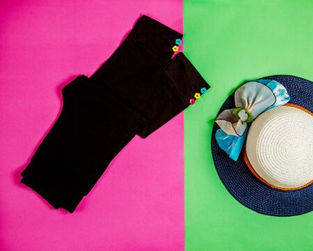 black girl leggings with flower shaped buttons and summer hatの写真素材