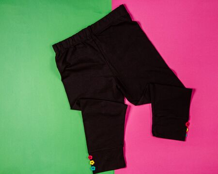 black girl leggings with flower-shaped buttons in the bottomの写真素材