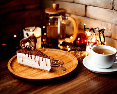 chocolate cheesecake and a cup of flavored teaの写真素材