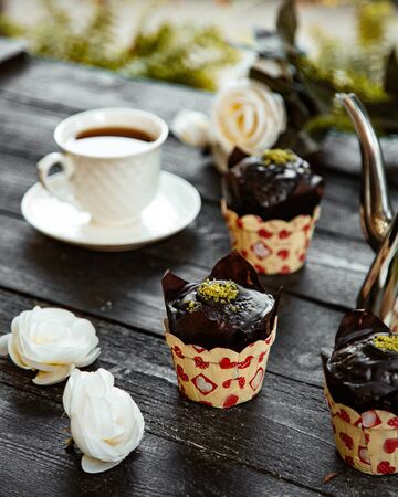 chocolate muffin and a cup of flavored teaの写真素材