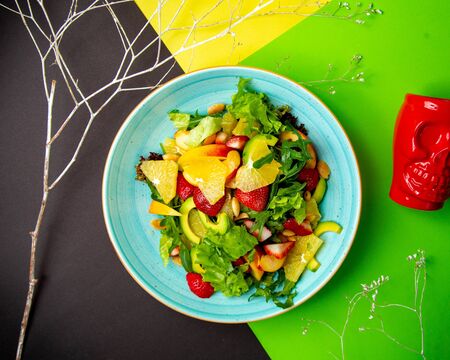 green salad with avocado lettuce orange strawberry peachの写真素材