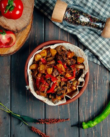 meat stew with fried potatoes, mushrooms, and pepperの写真素材
