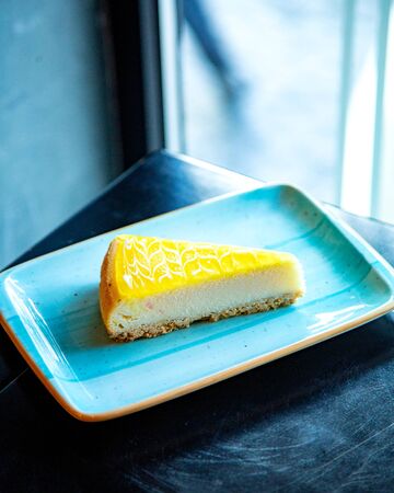 orange cheesecake on the tableの写真素材