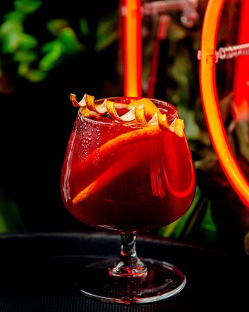 red cocktail with lemon on the tableの写真素材