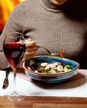 tuna salad with eggs and a glass of wineの写真素材