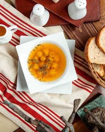 top view of dushbara dumpling soup garnished with dried mintの写真素材