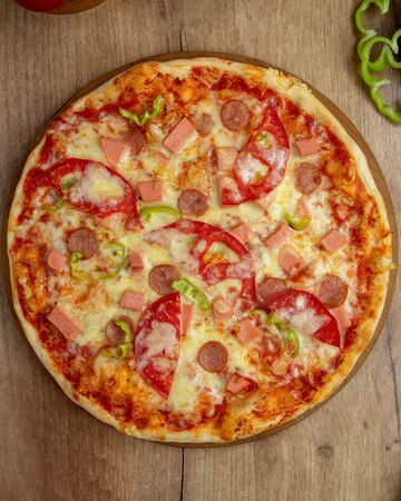 top view of pizza with sausages tomato bell pepper andの写真素材