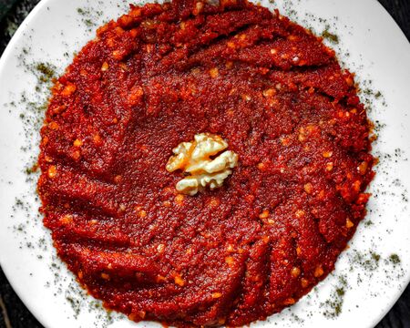 top view of spicy bell pepper mixture garnished with walnutの写真素材