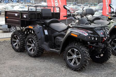 Perm, Russia - April 19, 2019: Modern ATV with a trailer for the transport of goods is on the site...