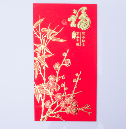 Chinese New Year - Mandarin orange, gold sycee (Foreign text means wealth) and red packetの写真素材