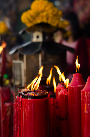 The flame on red candle at the Chinese temple.の写真素材
