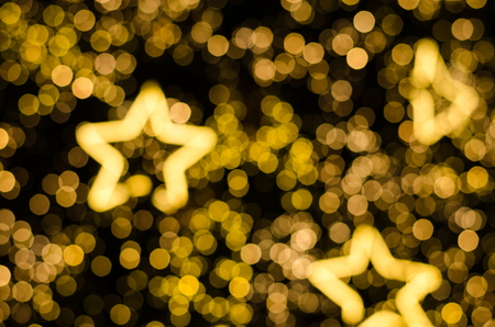 defocus blurred bokeh star sparkling gold backgroundの写真素材