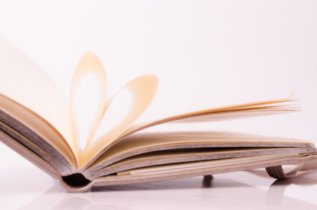 pages of a book curved into a heart shapeの写真素材