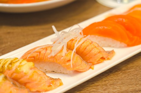 Fresh japanese salmon sushi on wood tableの写真素材