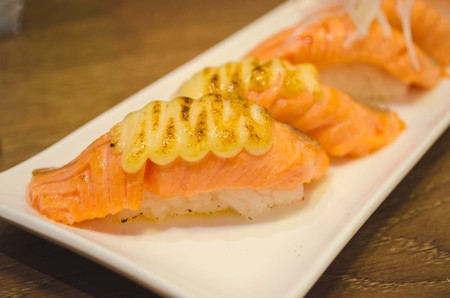 Fresh japanese salmon sushi on wood tableの写真素材