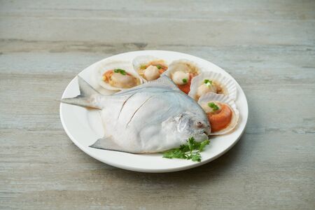 fish and scallop on the plateの写真素材