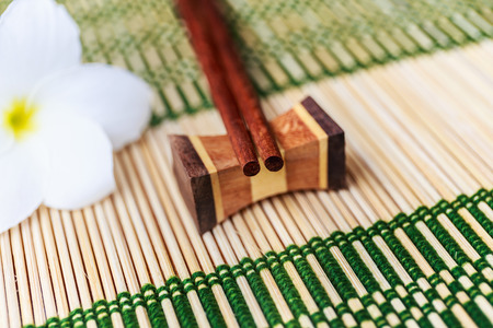 Chopsticks on the bamboo matの写真素材