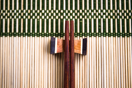Chopsticks on the bamboo matの写真素材