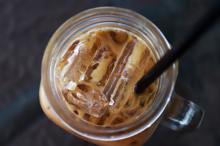 Ice coffee on the mirror tableの写真素材