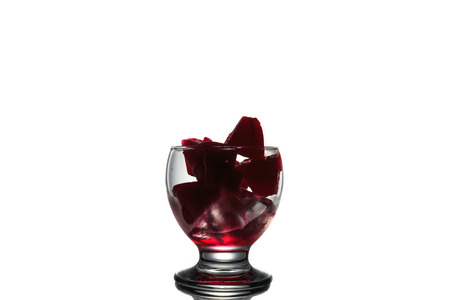 Red ice in the glass on white backgroundの写真素材