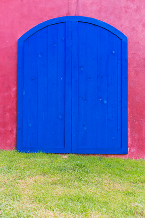 Blue door on the pink wall, backgroundの写真素材