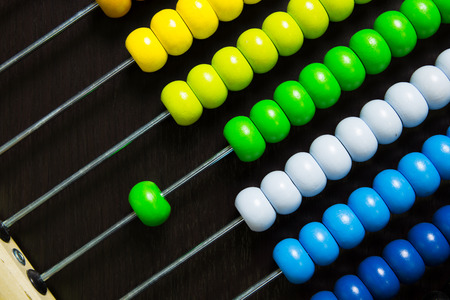 Colorful of wood abacus on black wooden floorの写真素材