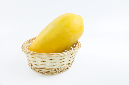 Yellow ripe papaya in the basket on white backgroundの写真素材