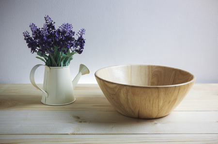Wooden bowl spoon and fork set with purple artificial flowerの写真素材