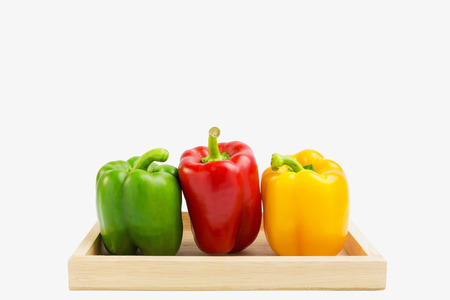 Fresh green, yellow and red pepper on wood box, including with clipping pathの写真素材