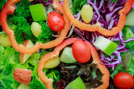 Kiwi sauce and mix salad with fruit and vegetable on wooden bowlの写真素材