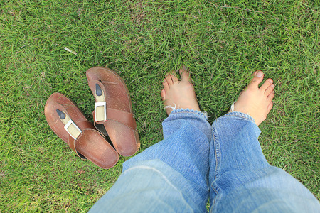 legs with shoes standing on grass