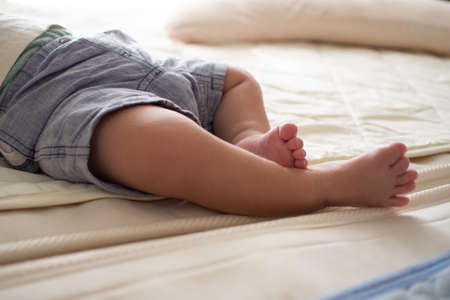 Japanese baby sleeping in bedの写真素材