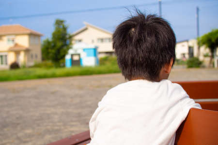 Japanese kindergarten children playing with playground equipment in a park in Gifu prefectureの写真素材