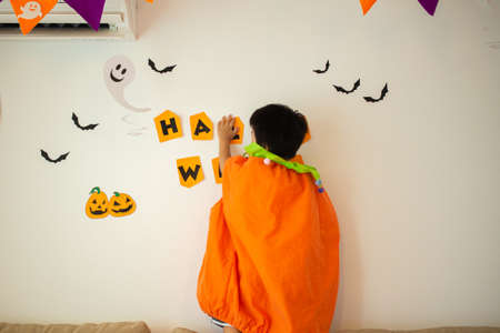 Japanese kids playing with Halloween decorations at home
