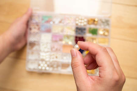 Photo of holding handmade accessory parts by hand