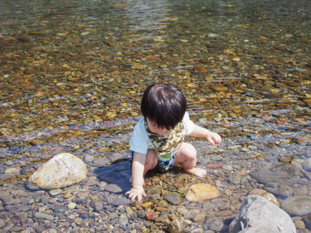 Japanese children playing in a very beautiful river in Gujo City, Gifu Prefectureの写真素材
