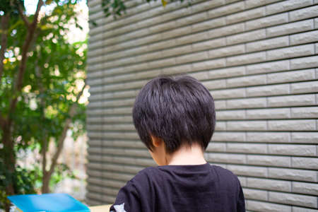 Japanese children playing in a garden with Griffith's ash treesの写真素材